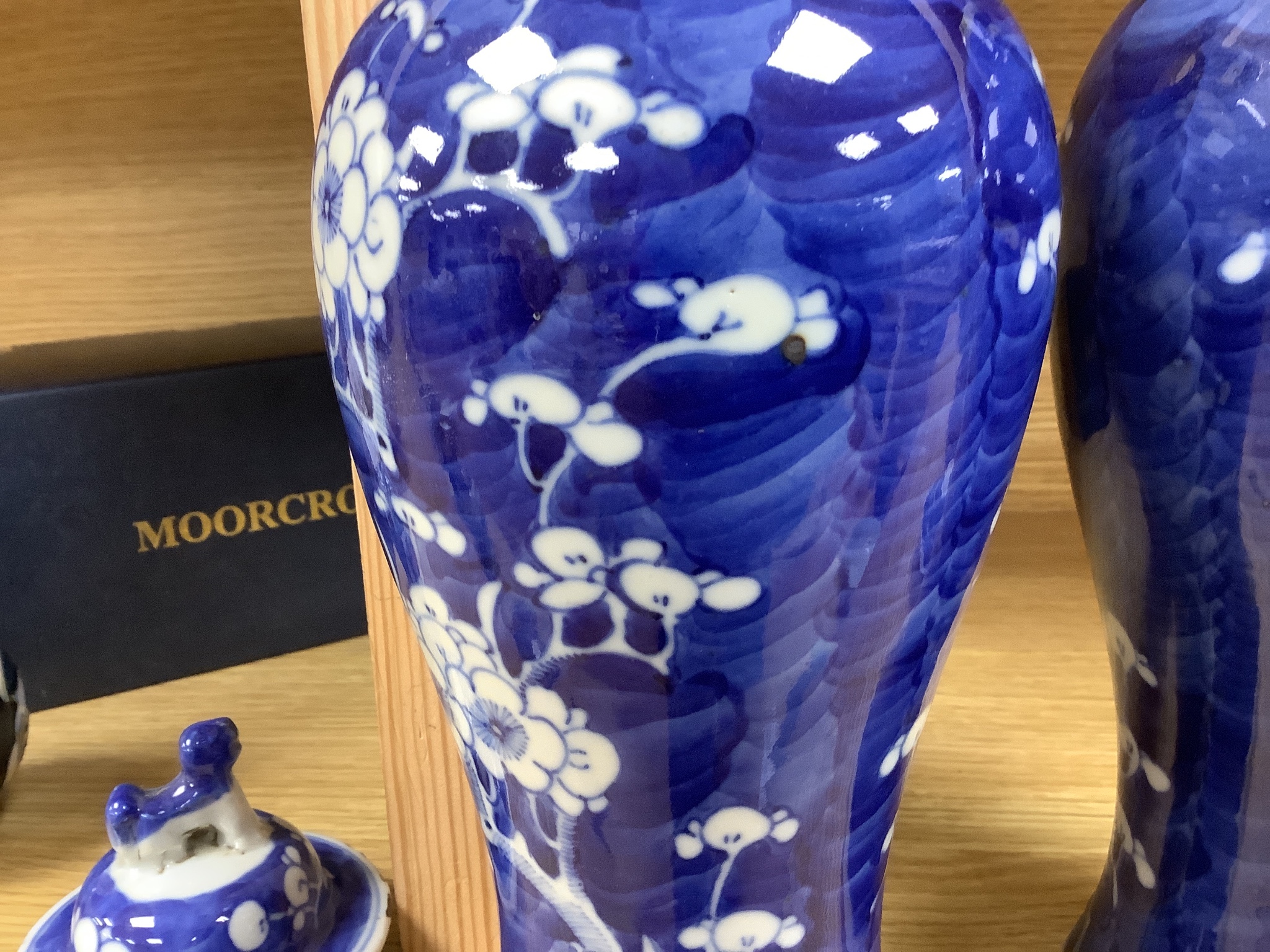 A pair of early 20th century Chinese blue and white prunus vases and covers, height 30cm